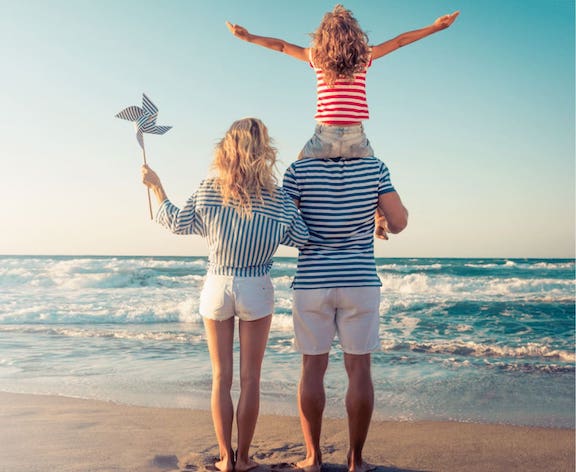 Happy family of three at the beach