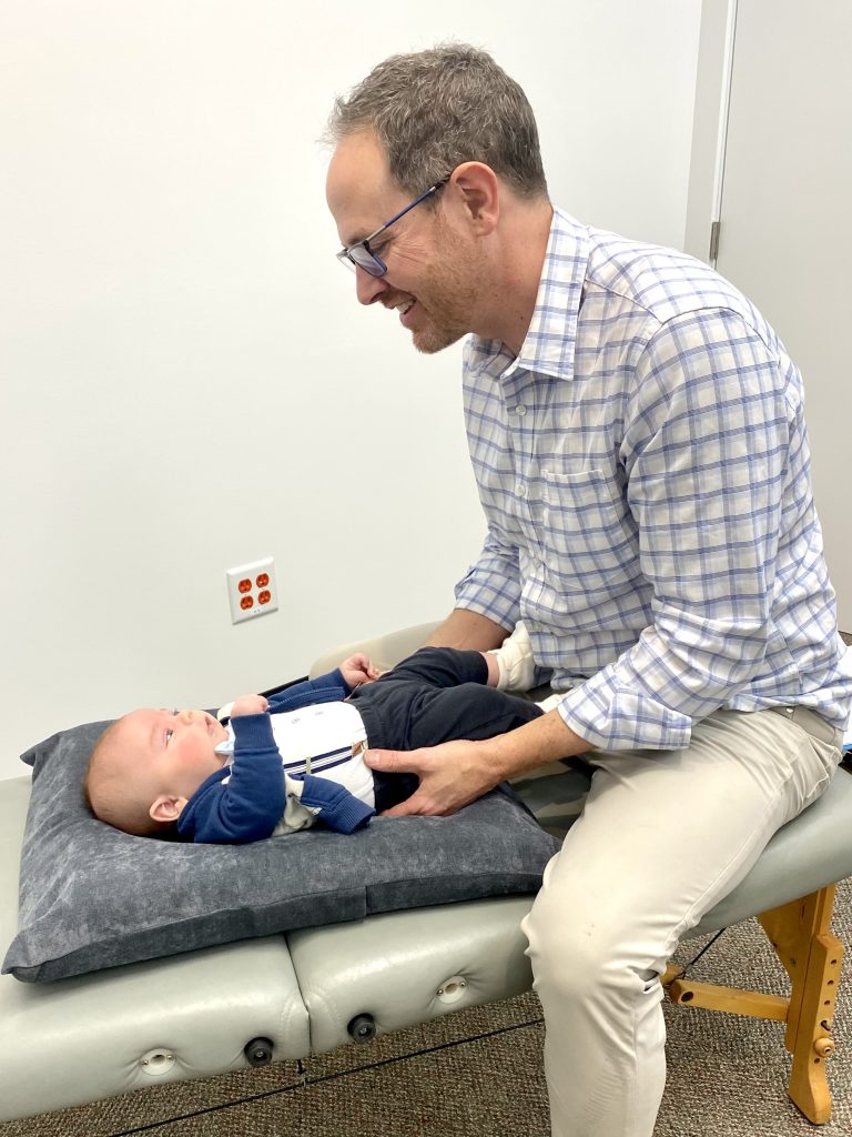 Dr. Chad giving chiropractic care to a baby