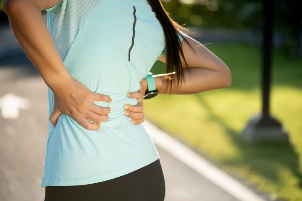 Woman on a job experiencing lower back pain