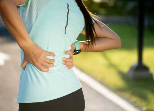 Woman on a job experiencing lower back pain