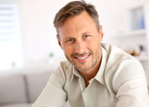 Photo of a happy man after EMSELLA® for men treatments